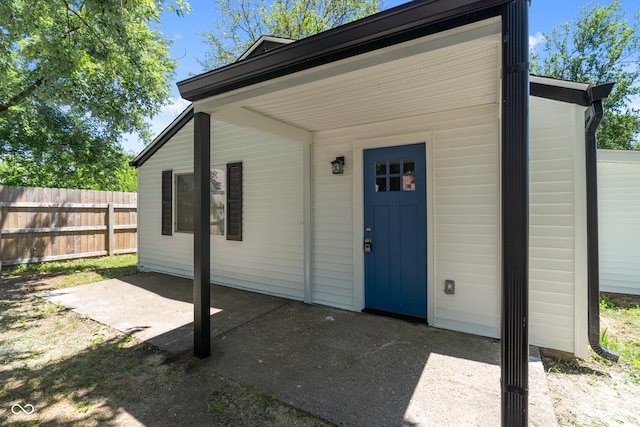 view of exterior entry featuring a patio area