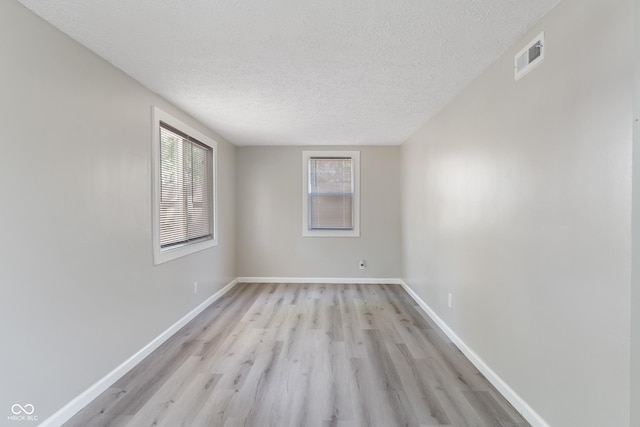 929 Olin Ave, Indianapolis, IN 46222 - empty room featuring light hardwood / wood-style floors and a textured ceiling