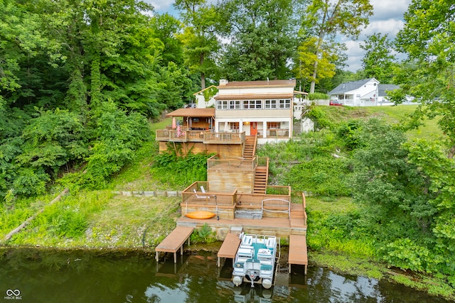 rear view of property with a deck with water view