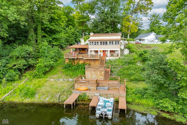 rear view of property featuring a deck with water view