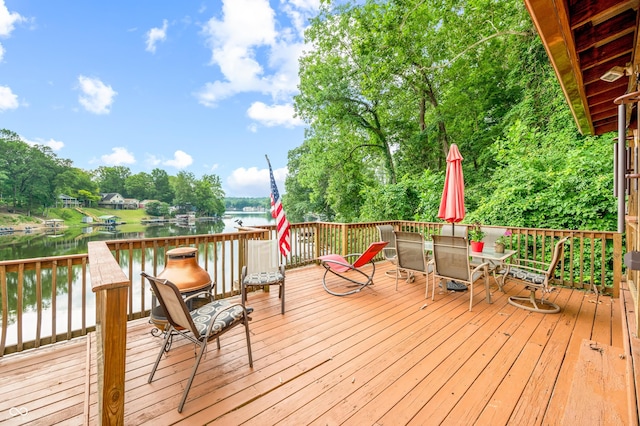 wooden deck featuring a water view