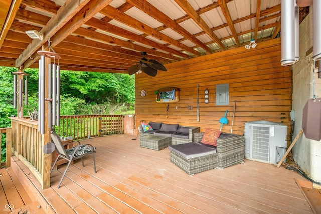 wooden deck featuring cooling unit, ceiling fan, an outdoor living space, and electric panel