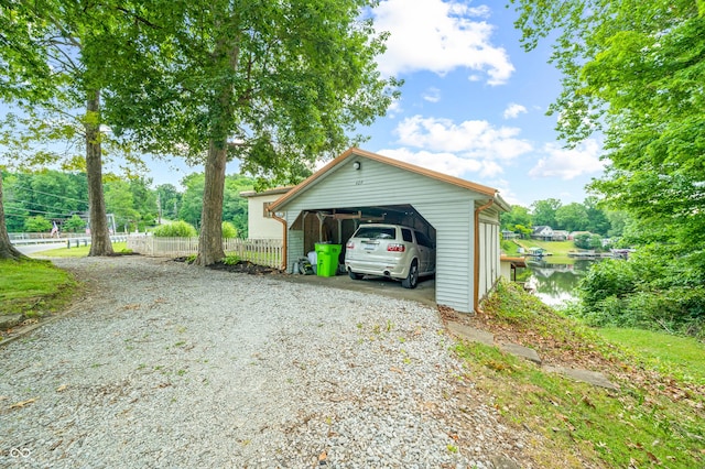 garage featuring a water view and a carport