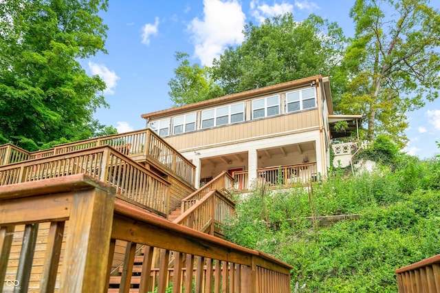 back of property featuring a wooden deck