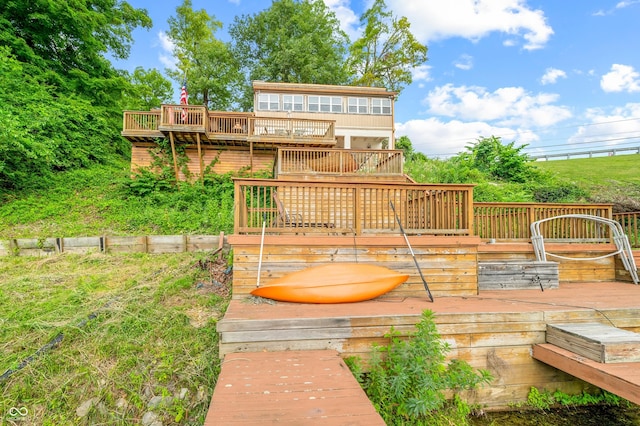 rear view of house featuring a wooden deck