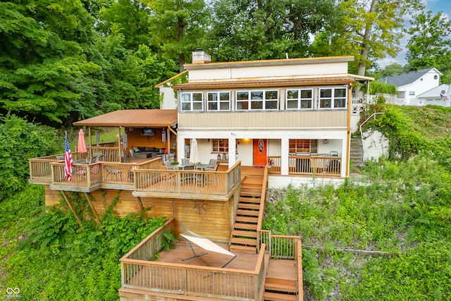 rear view of house featuring a deck