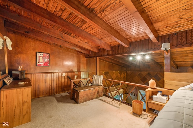 carpeted bedroom featuring wooden walls, beam ceiling, and wooden ceiling