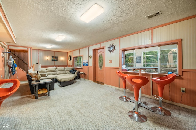 living room featuring carpet flooring and a textured ceiling