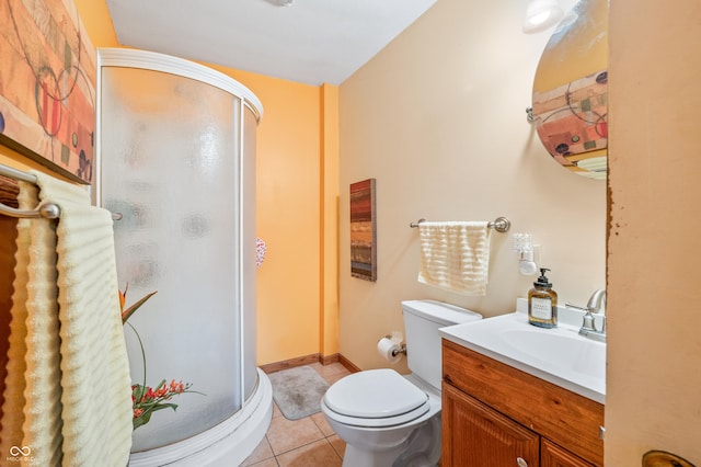 bathroom with toilet, vanity, a shower with door, and tile patterned flooring