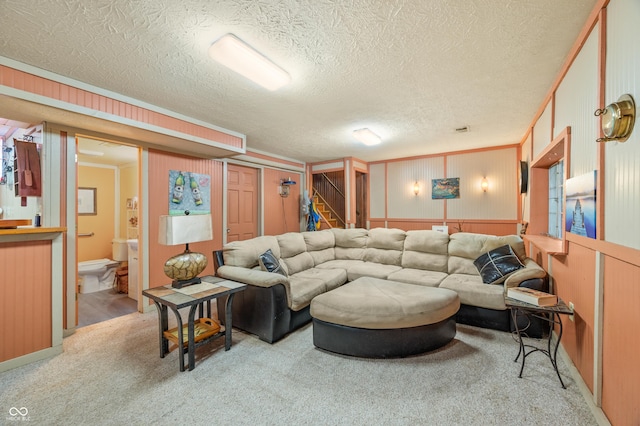 carpeted living room featuring ornamental molding and a textured ceiling