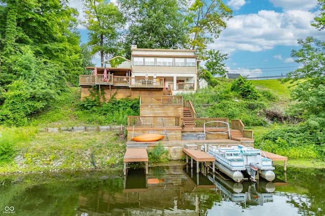 back of house featuring a deck with water view