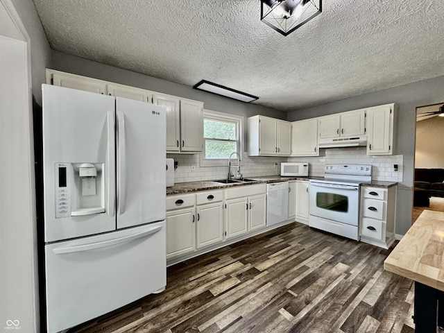 kitchen featuring white appliances, dark wood-type flooring, white cabinets, sink, and decorative backsplash