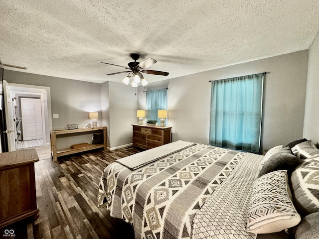 bedroom featuring ceiling fan, dark hardwood / wood-style flooring, and a textured ceiling