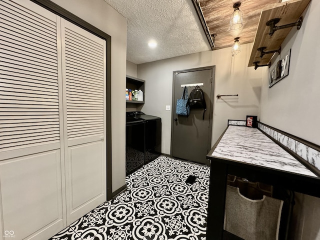 kitchen with washing machine and dryer, wooden ceiling, and a textured ceiling