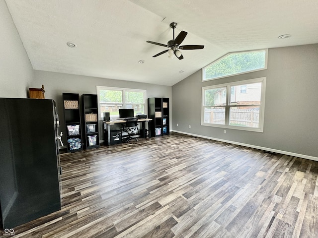 unfurnished office with ceiling fan, wood-type flooring, a textured ceiling, and lofted ceiling