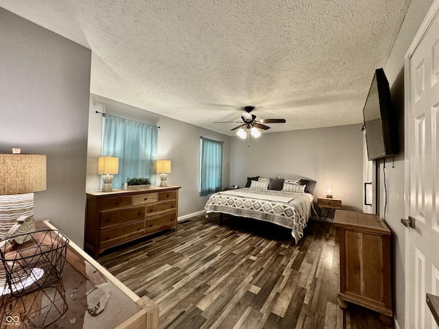 bedroom with a textured ceiling, ceiling fan, and dark hardwood / wood-style floors