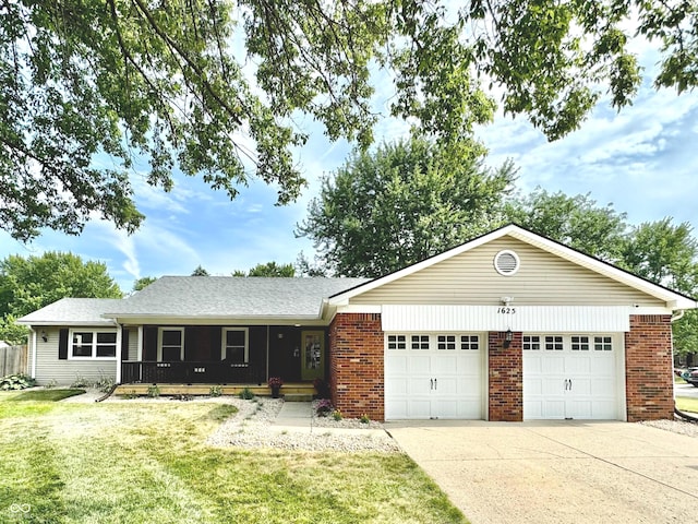 ranch-style home featuring a front lawn, covered porch, and a garage