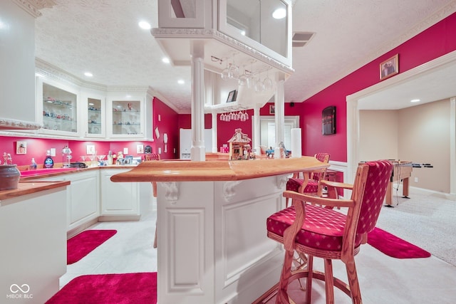 8292 S State Road 39th Rd S, Clayton, IN 46118 - kitchen with a textured ceiling, white cabinets, glass insert cabinets, a breakfast bar area, and recessed lighting