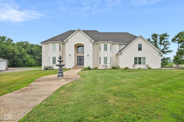 view of front of home featuring a garage and a front yard