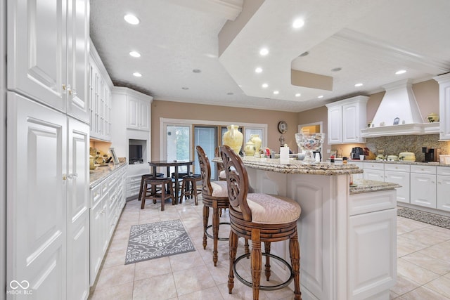 8292 S State Road 39th Rd S, Clayton, IN 46118 - kitchen with recessed lighting, backsplash, a kitchen breakfast bar, light tile patterned floors, and a center island
