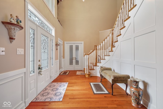 entrance foyer with wood-type flooring and a high ceiling