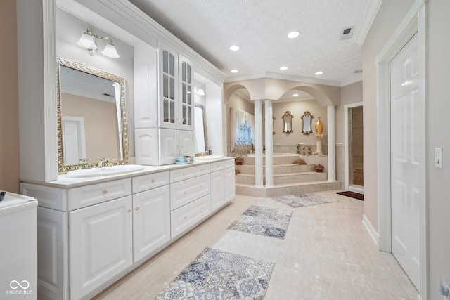 bathroom featuring ornamental molding, tile patterned floors, a textured ceiling, and double vanity