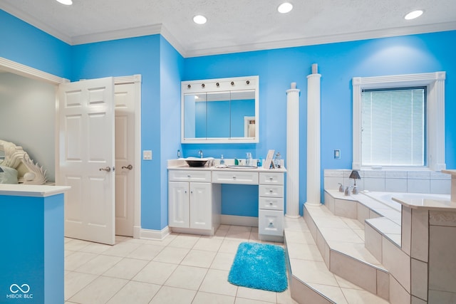 bathroom featuring vanity, tiled bath, tile patterned floors, crown molding, and a textured ceiling