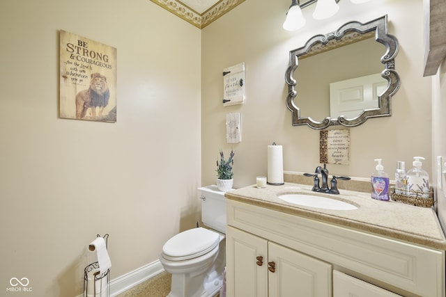 bathroom featuring crown molding, toilet, and vanity