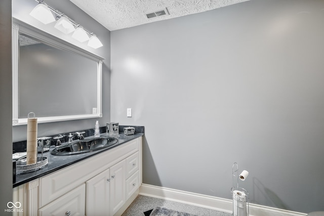 bathroom featuring vanity and a textured ceiling