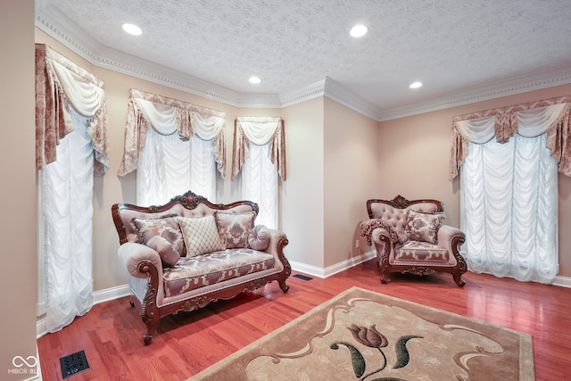 living area featuring a textured ceiling and hardwood / wood-style floors