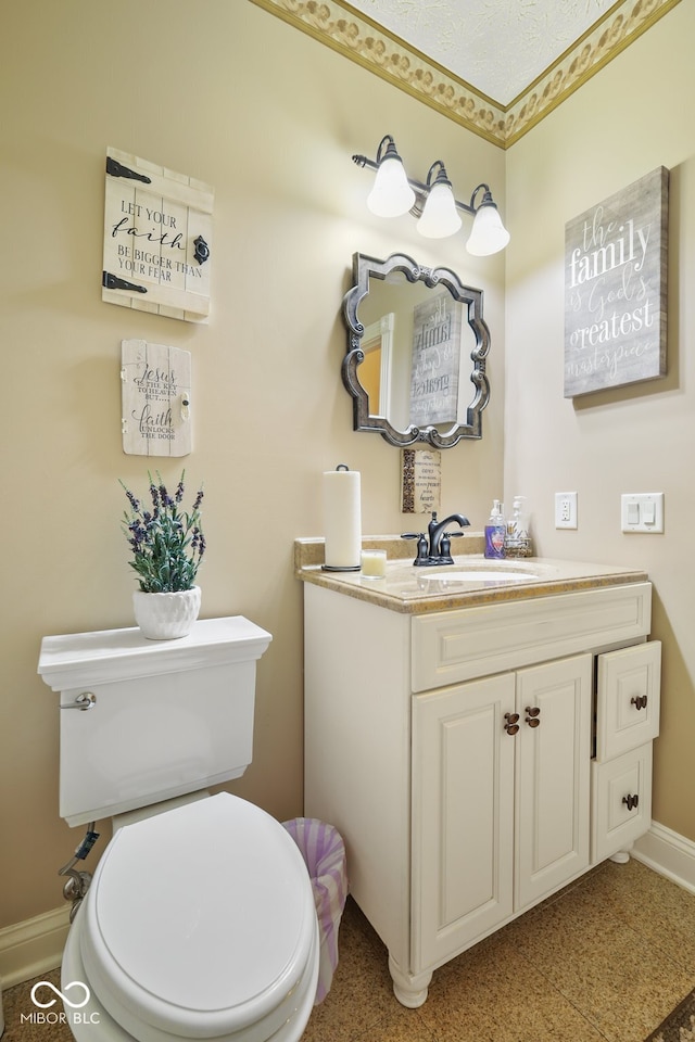 bathroom with toilet, vanity, and a textured ceiling