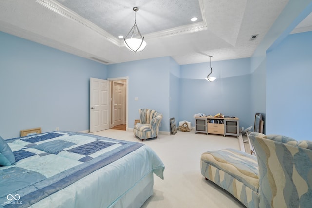 carpeted bedroom with a textured ceiling and a tray ceiling