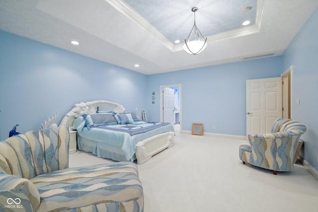 carpeted bedroom featuring a textured ceiling and a tray ceiling