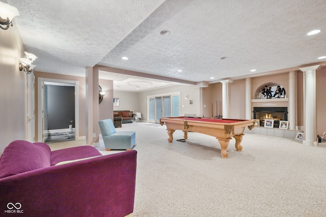 recreation room featuring a fireplace, built in features, and a textured ceiling