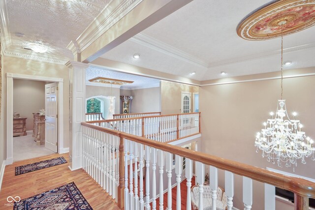 8292 S State Road 39th Rd S, Clayton, IN 46118 - corridor with an upstairs landing, wood finished floors, crown molding, a chandelier, and a textured ceiling
