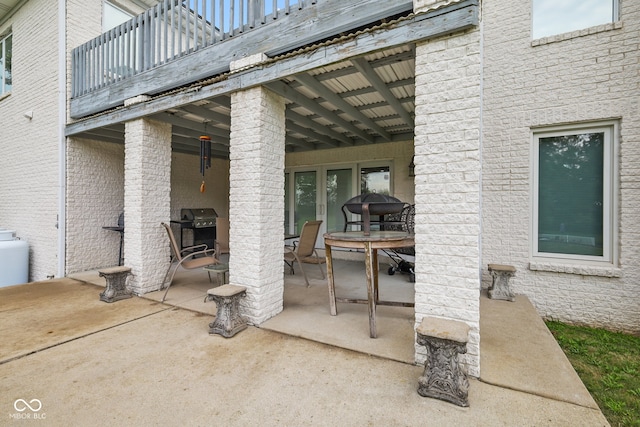 view of patio / terrace with area for grilling and a balcony