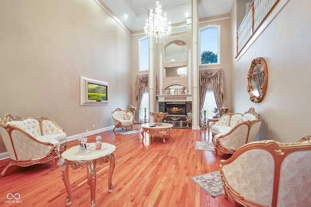 living room with a fireplace, hardwood / wood-style floors, and a high ceiling