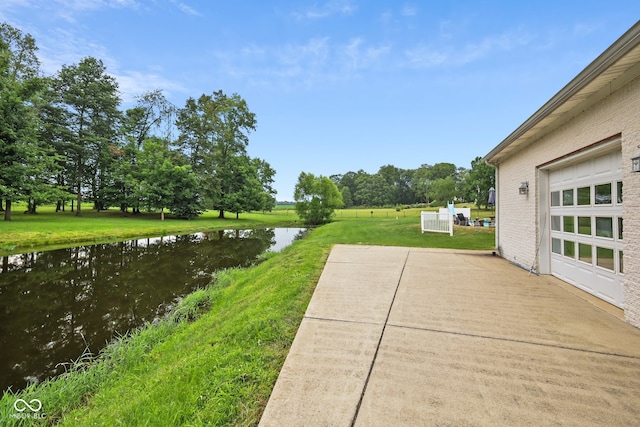 view of yard featuring a patio area and a water view