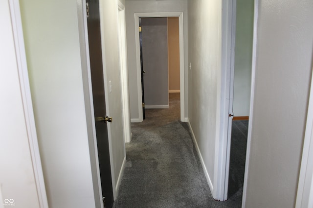 corridor with dark colored carpet