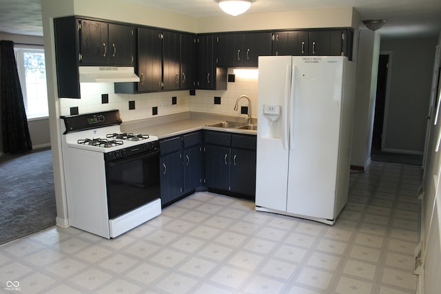 kitchen with tasteful backsplash, white appliances, sink, light carpet, and custom range hood