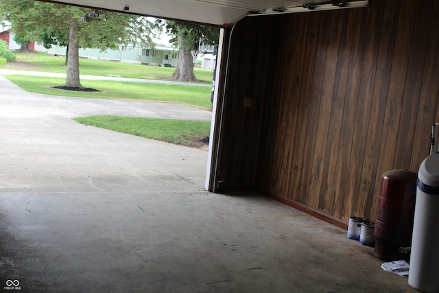 garage with wood walls and a yard