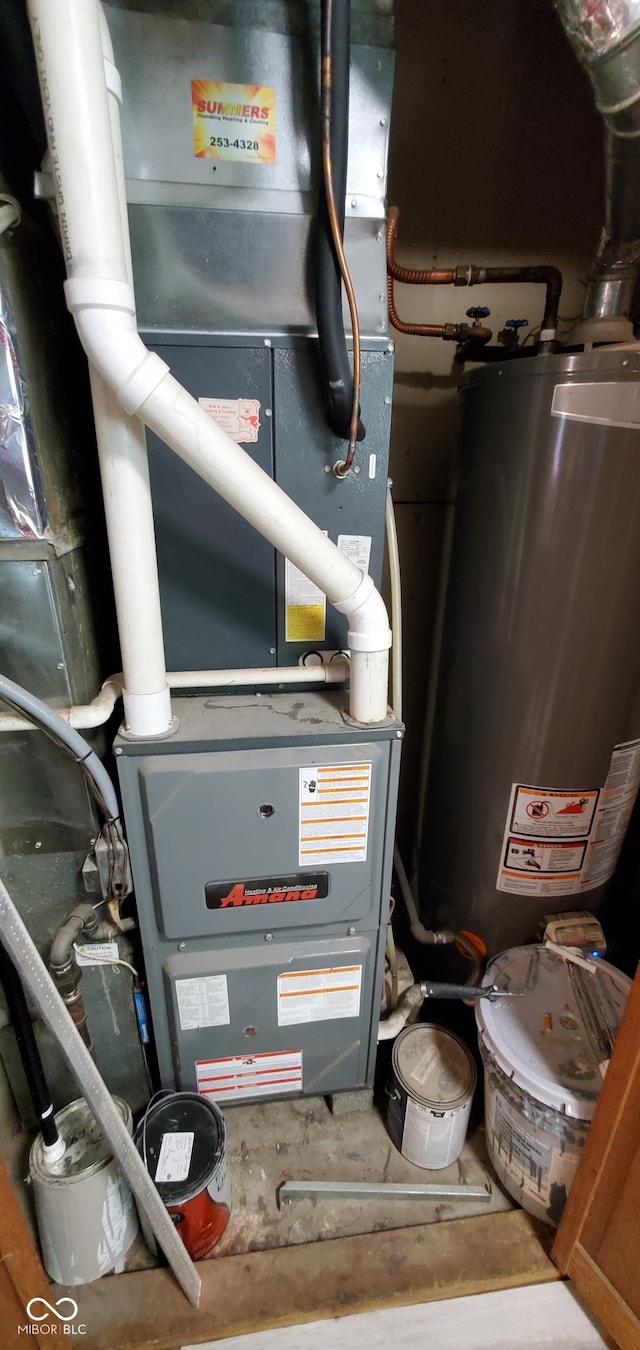 utility room featuring heating utilities and water heater