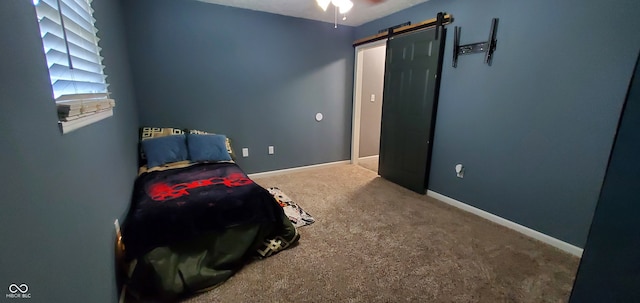 carpeted bedroom with a barn door