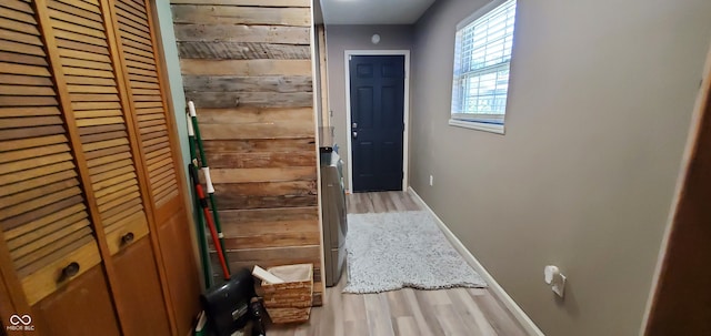 corridor with wood-type flooring and wood walls