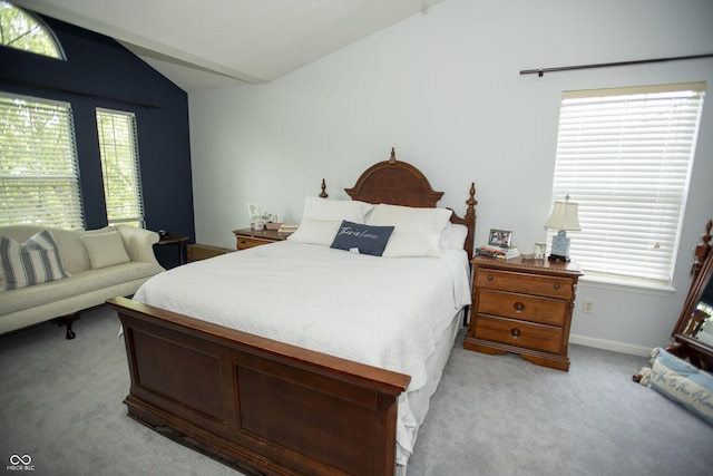 bedroom with vaulted ceiling and light carpet