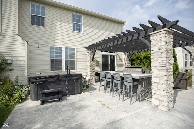 view of patio / terrace featuring a hot tub, a pergola, an outdoor bar, and grilling area