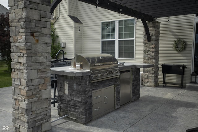 view of patio with grilling area, area for grilling, and a pergola