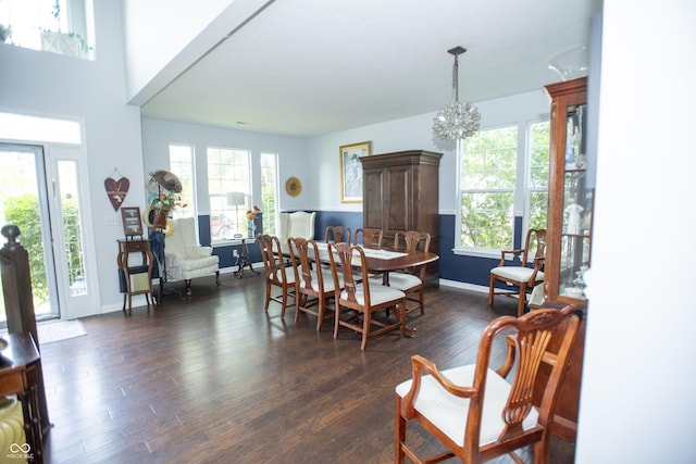 dining space with an inviting chandelier and dark hardwood / wood-style floors