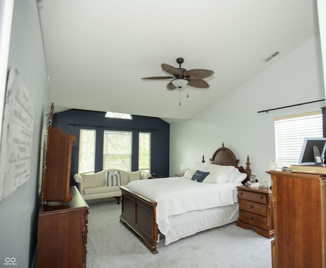 carpeted bedroom with vaulted ceiling and ceiling fan