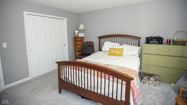 bedroom featuring a closet and light carpet